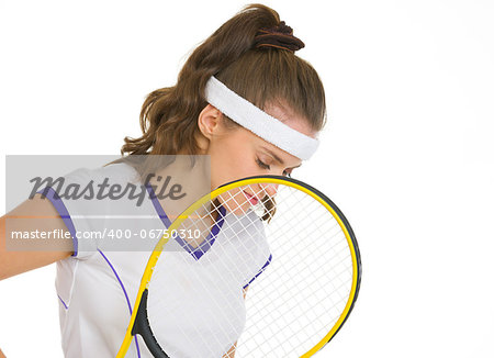 Thoughtful female tennis player holding racket