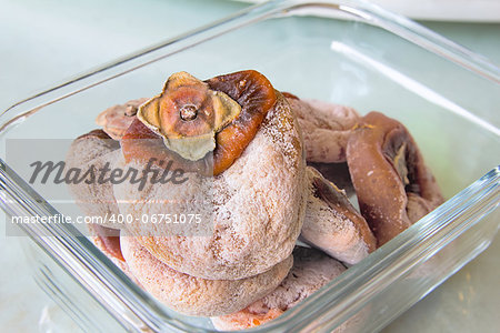 Sun Dreid Persimmons in Glass Container