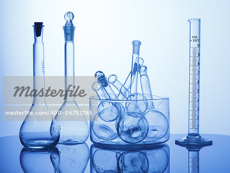 Research Lab assorted Glassware Equipment on blue background Research Lab assorted Glassware Equipment on blue background
