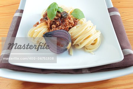 Italian spaghetti with onion on square plate