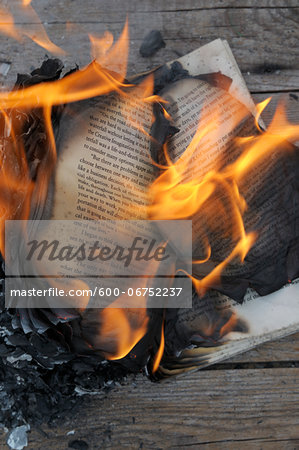 Burning Book on Wooden Background