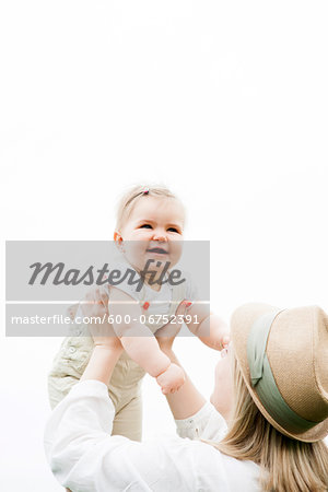 Portrait of Mother Lifting Daughter in the Air, Mannheim, Baden-Wurttemberg, Germany