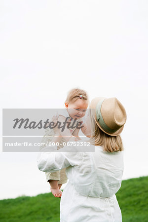 Portrait of Mother Lifting Daughter in the Air, Mannheim, Baden-Wurttemberg, Germany