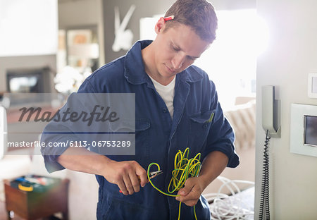 Electrician cutting wires in home