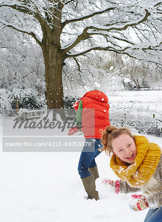 Mother and daughter playing in snow