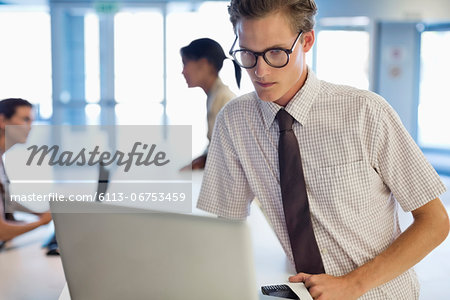 Businessman using laptop at desk