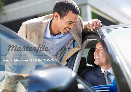 Businessmen talking in car