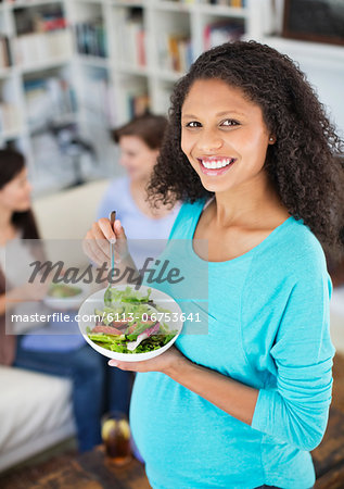 Pregnant woman eating salad