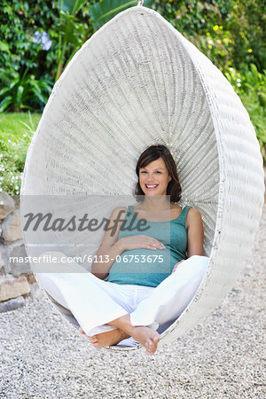 Pregnant woman relaxing outdoors