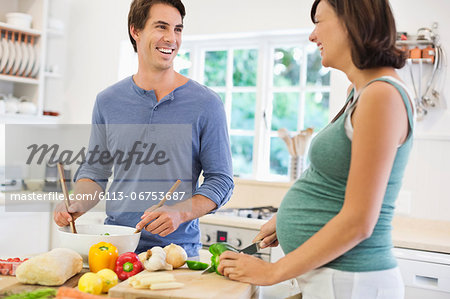 Couple cooking together in kitchen