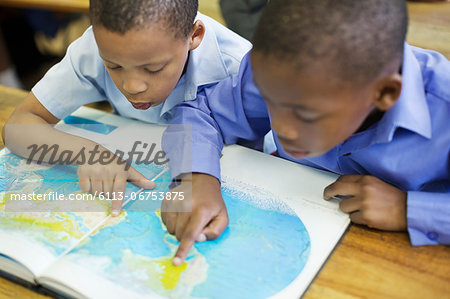 Students using world map in class