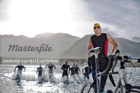 Triathletes emerging from water