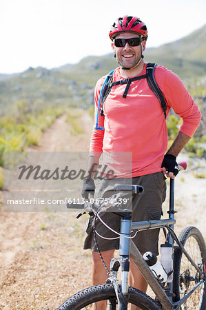 mountain biker smiling on dirt path