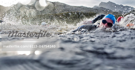 Swimmers splashing in water