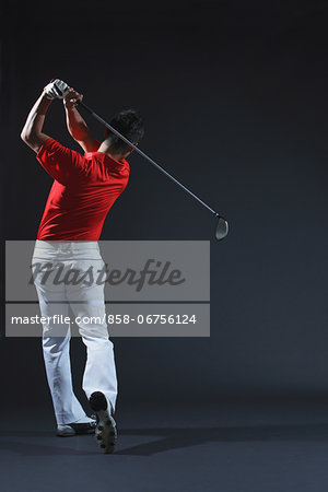 Golfer Swinging,  Rear View