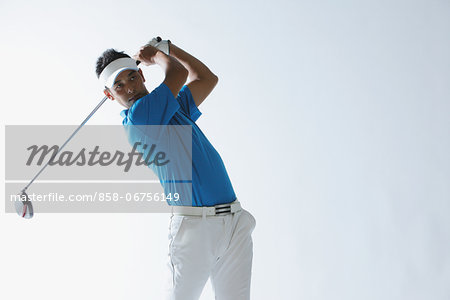 Portrait Of Golfer Swinging