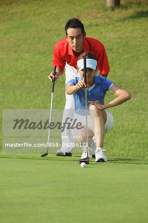 Female Golfer Preparing To Shot