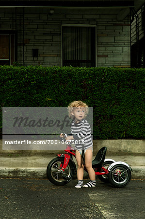 Boy with Bicycle on Neighbourhood Street Boy with Bicycle on Neighbourhood Street