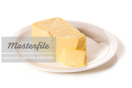 Block of butter on a white plate on white seamless background
