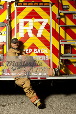 Fire Fighter Sitting on Back of Fire Truck, Ontario