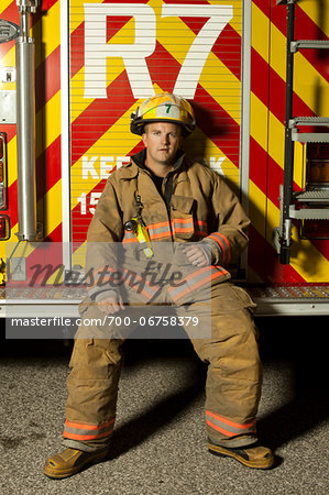 Fire Fighter Sitting on Back of Fire Truck, Ontario