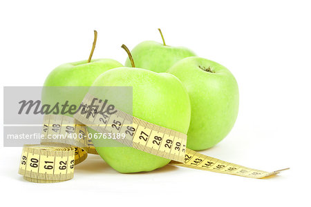 Green apples and yellow measuring tape isolated on white background