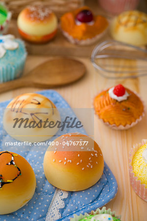 sweet vanilla bun cake bread with pastry decorations as background