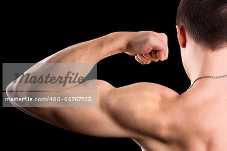 strong biceps on a black background