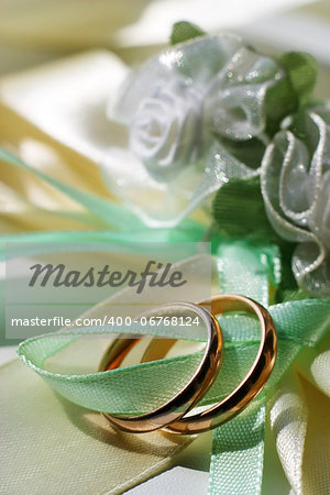 Wedding rings on a blue satiny fabric