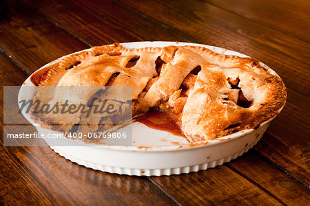 Freshly baked apple pie with a missing portion