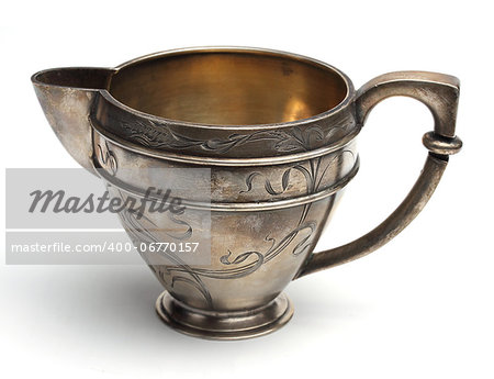 Antiquarian the silver jug for milk on a white background