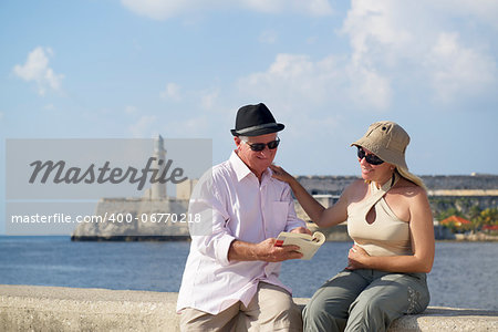 Tourism and active retirement with elderly people traveling, senior couple having fun on holidays in Havana, Cuba