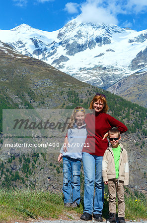 Family (mother with children) walk on summer Alps mountain plateau (Switzerland, near Zermatt)