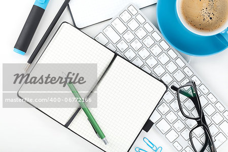 Blue coffee cup and office supplies. View from above. Closeup on white background