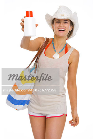 Happy beach young woman showing sun block creme