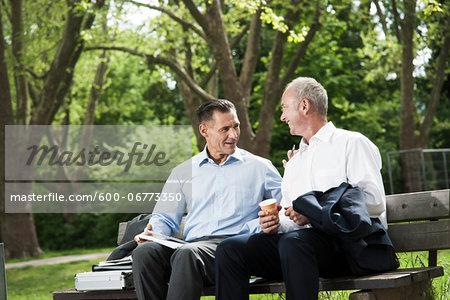 Businessmen Talking on Park Bench, Mannheim, Baden-Wurttemberg, Germany Businessmen Talking on Park Bench, Mannheim, Baden-Wurttemberg, Germany