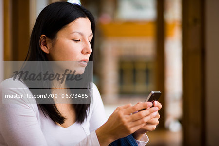 Woman sending a text message on a smart phone.