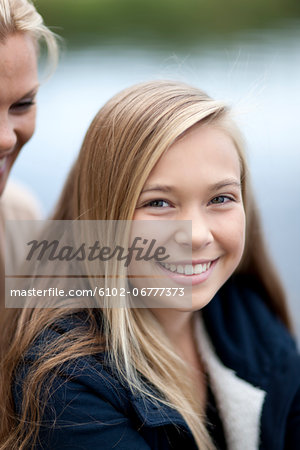 Portrait of girl with mother in background