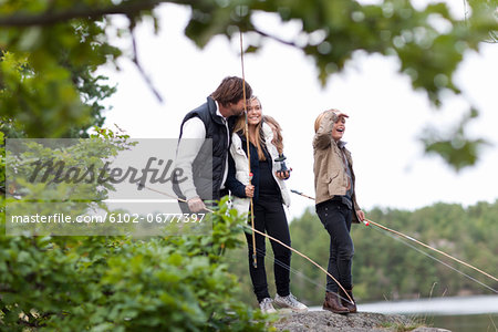 Father with two children fishing