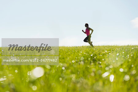 Woman jogging in meadow