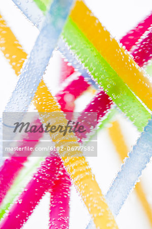 Studio shot of colorful drinking straws in water