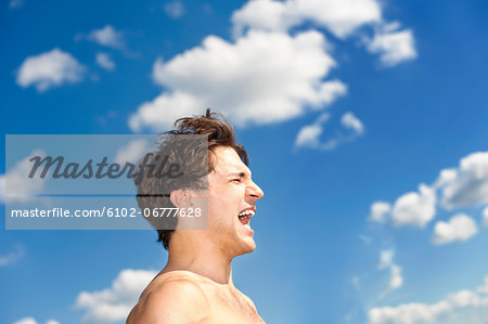 Laughing man against sky