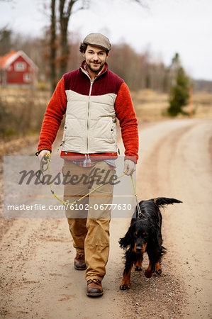 Smiling man walking dog