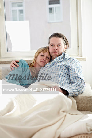 Couple Relaxing On Sofa, Portrait Couple Relaxing On Sofa, Portrait