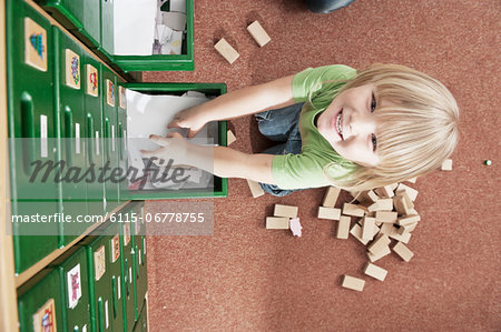 Little Boy Standing On Cupboard In Nursery School, Kottgeisering, Bavaria, Germany, Europe
