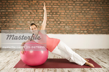 Woman Doing Pilates With Fitness Ball, Munich, Bavaria, Germany, Europe