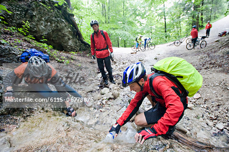 Mountain Bikers By River, Schwangau-Bleckenau, Bavaria, Germany Mountain Bikers By River, Schwangau-Bleckenau, Bavaria, Germany