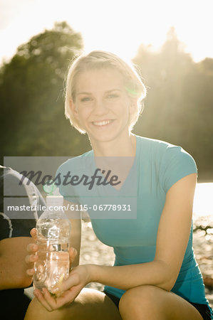 Young woman holding water bottle, Munich, Bavaria, Germany
