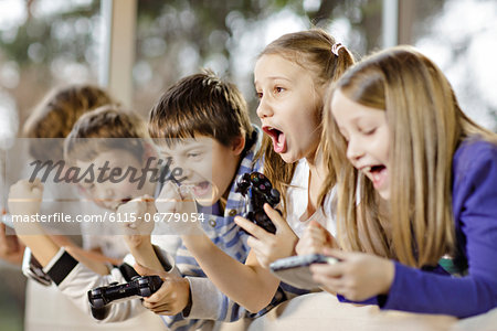 Children playing video game, Osijek, Croatia, Europe