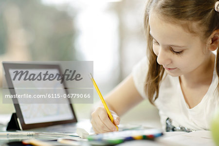 Girl using digital tablet and doing homework, Osijek, Croatia, Europe